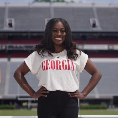 Latia standing in front of a stadium