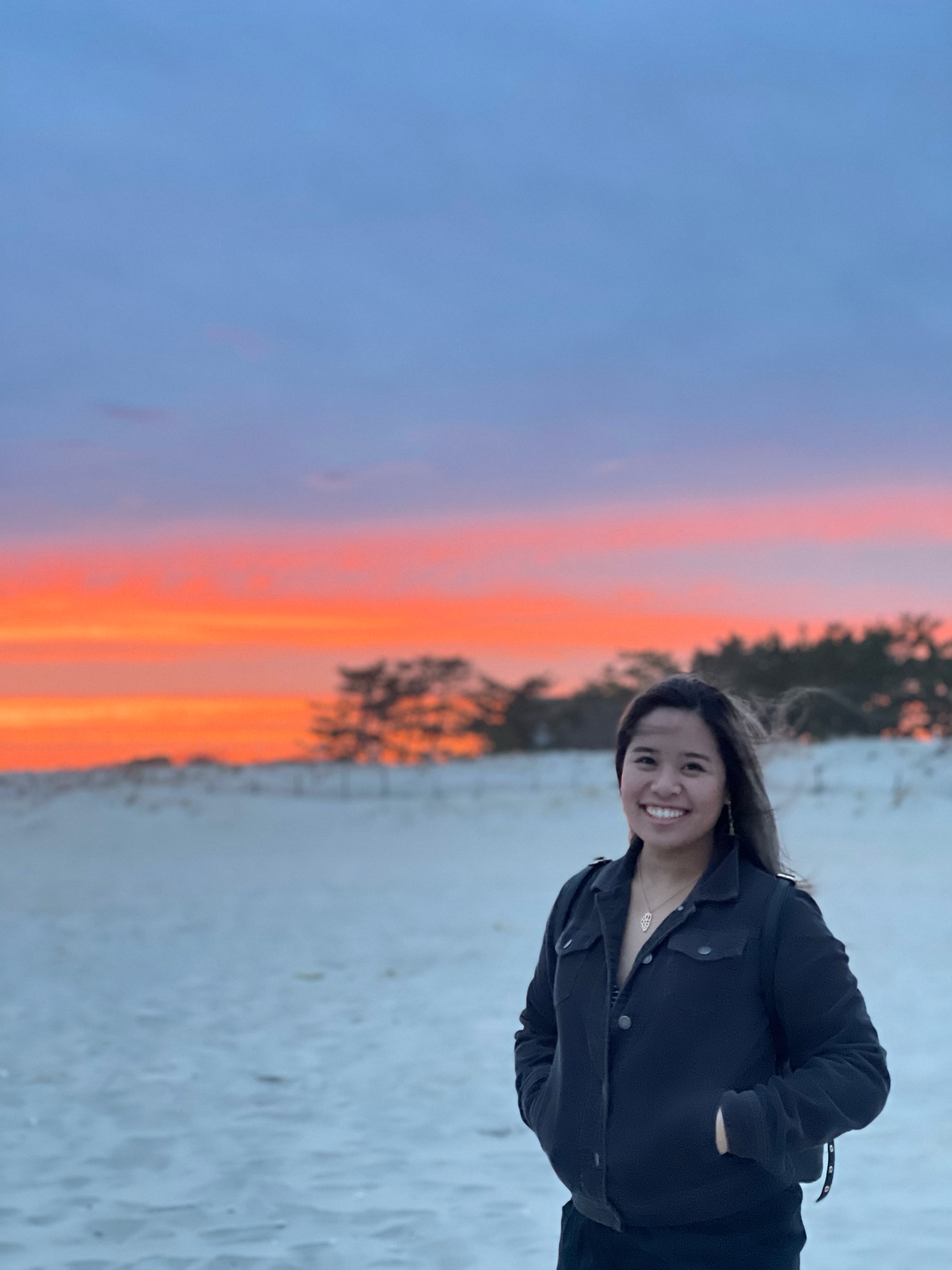 Michelle standing in front of a sunset